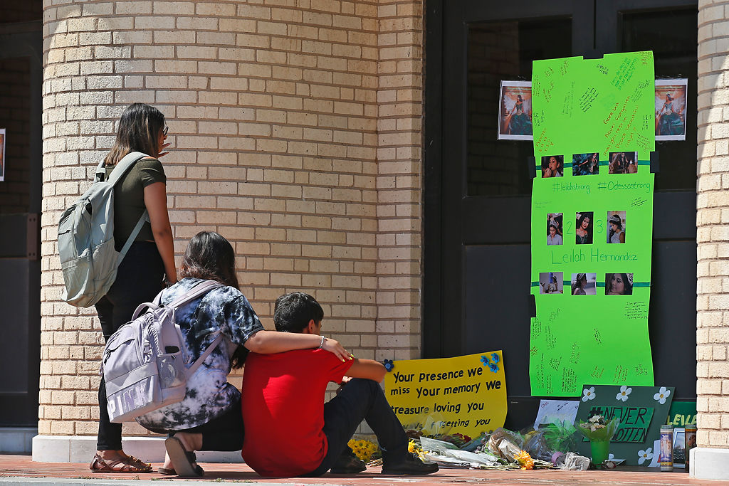 In this Sept. 3, 2019, file photo, people gather at a memorial for slain high school student Leilah Hernandez at Odessa High School in Odessa, Texas.